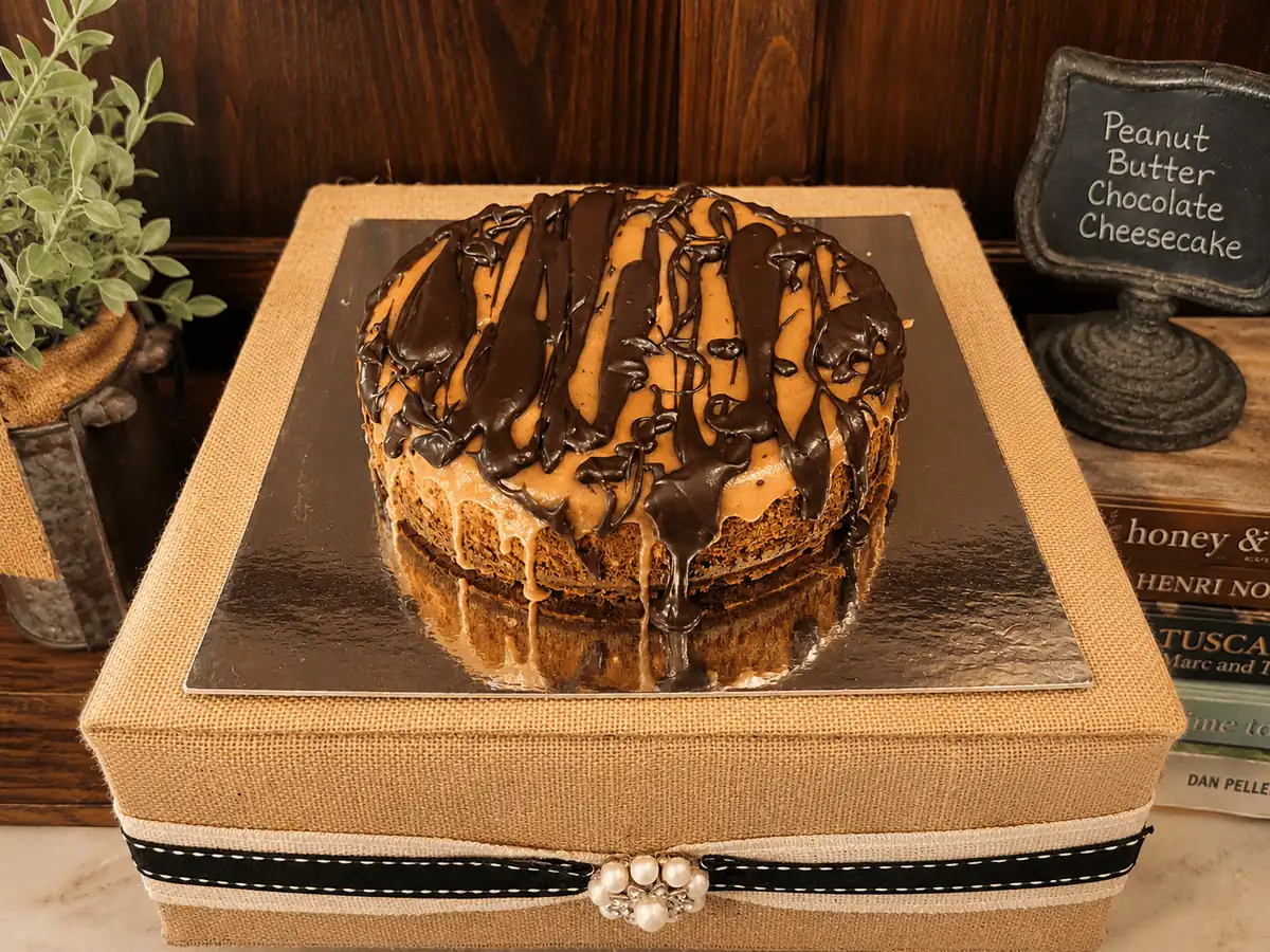 Custom peanut butter chocolate cheesecake with chocolate drizzle